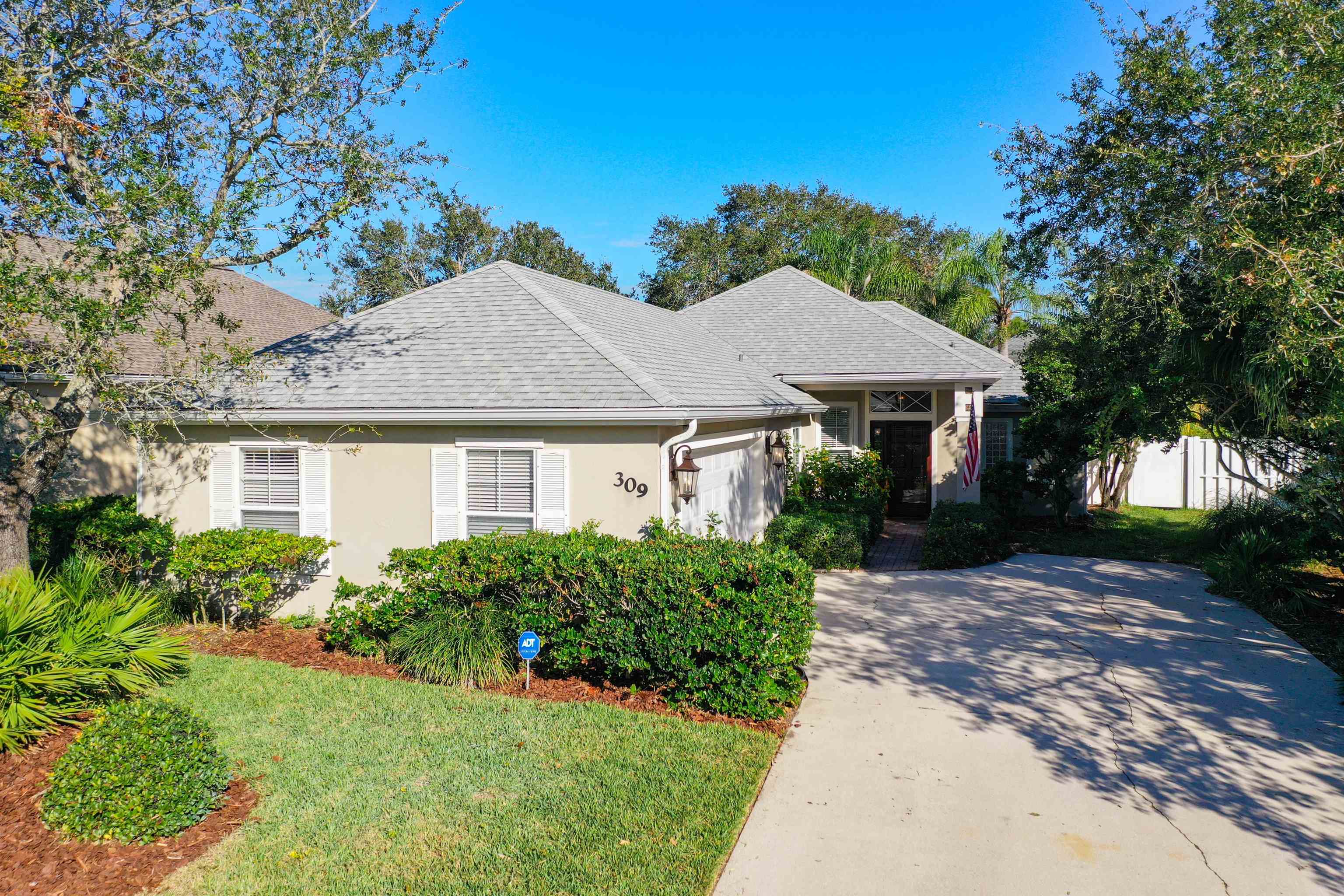 a front view of a house with a garden