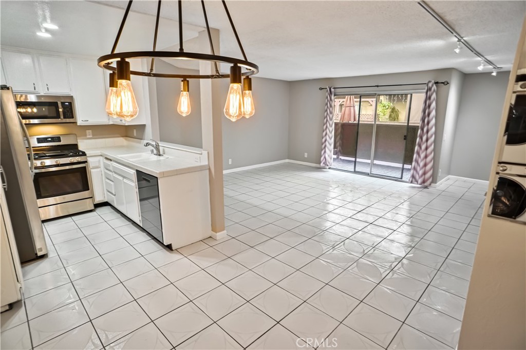 a kitchen with stainless steel appliances a stove a sink and a refrigerator