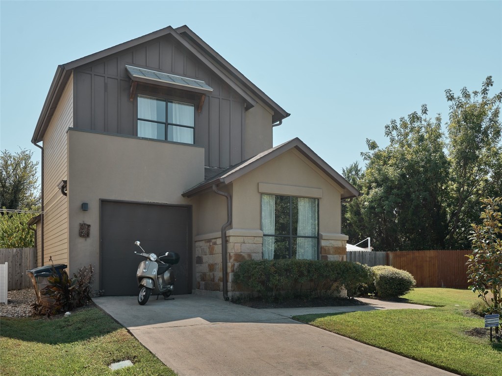 a front view of a house with yard and green space