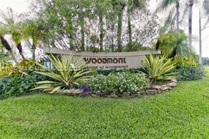 a view of sign board with tall trees