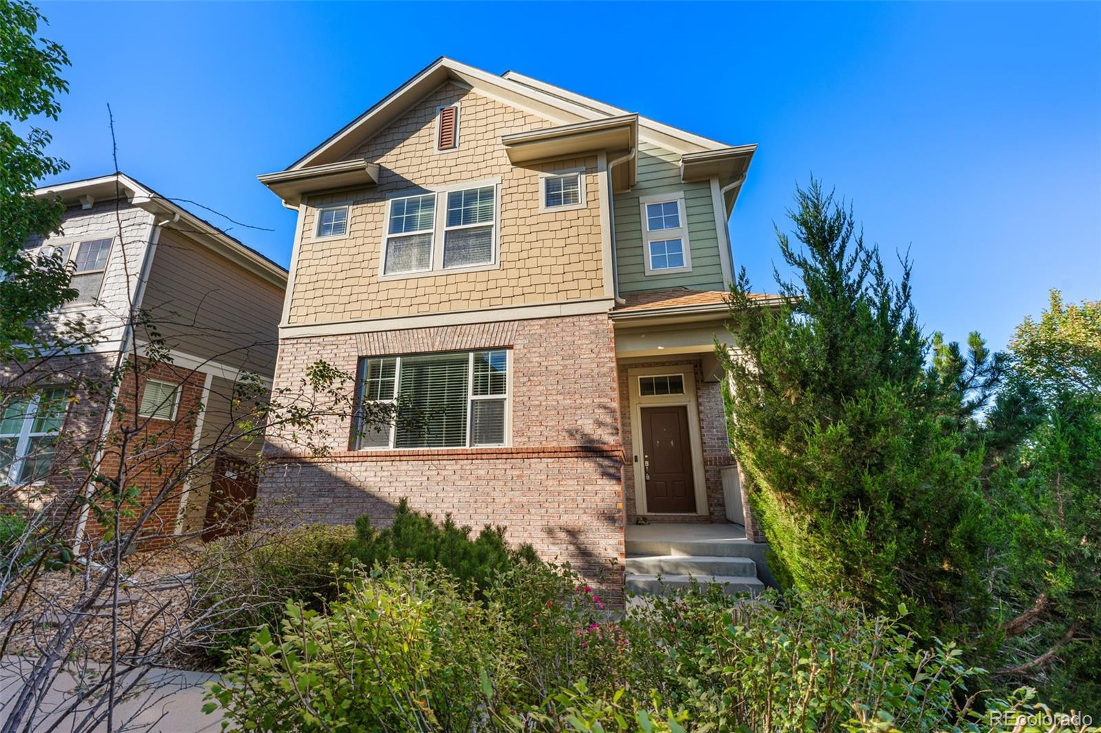 a front view of a house with a garden