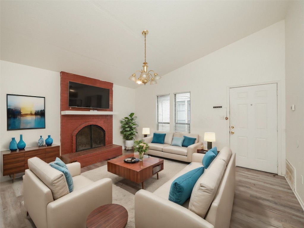 a living room with furniture a fireplace and a flat screen tv