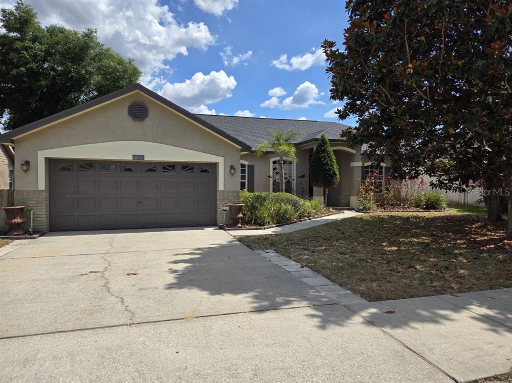 a front view of a house with a yard and garage