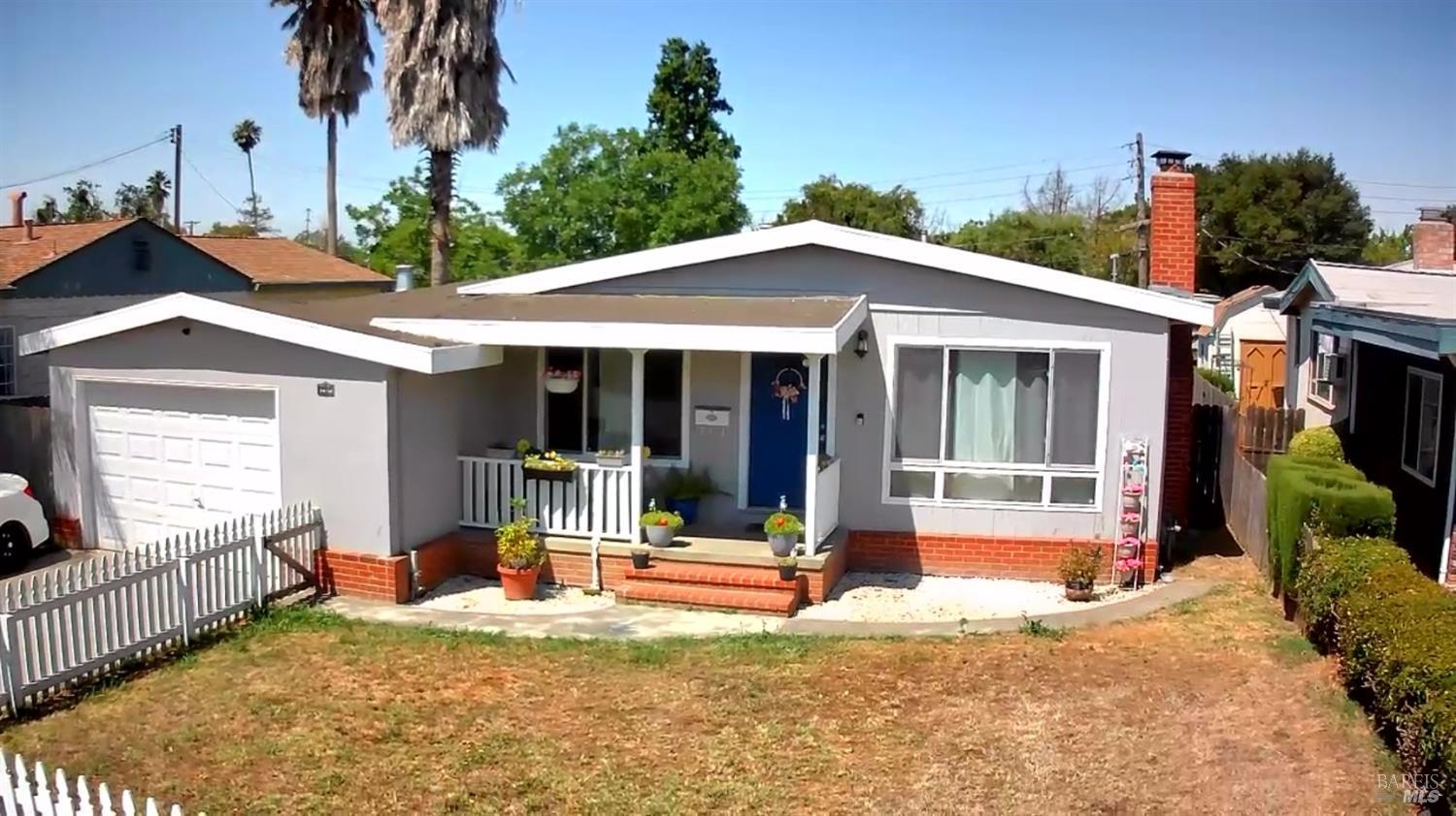 a view of a house with backyard and porch