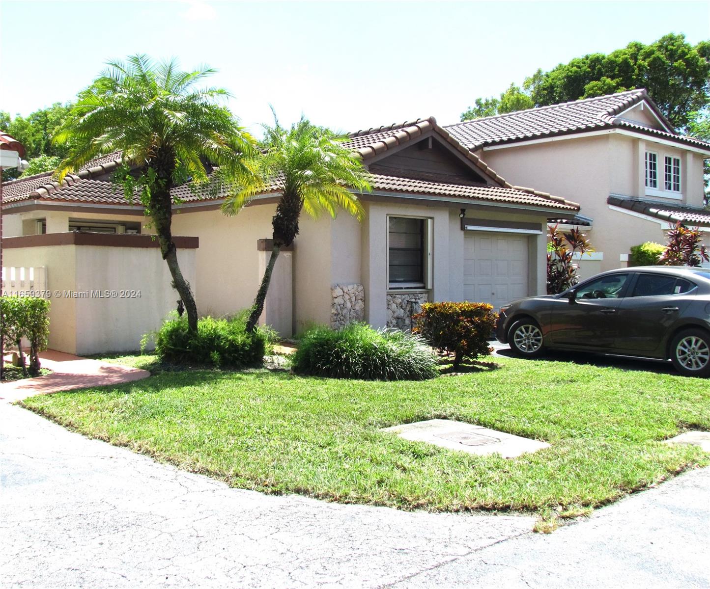 a front view of house with yard and green space