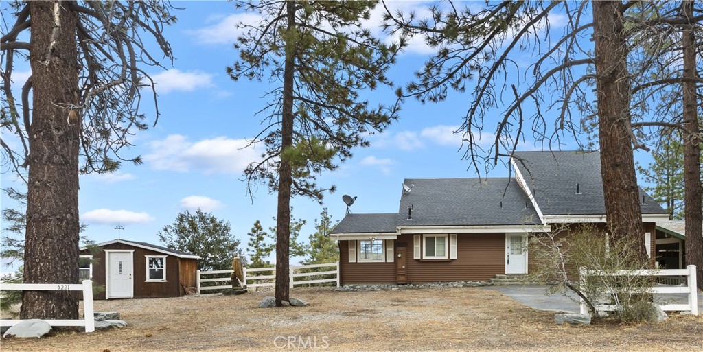 front view of a house with a tree