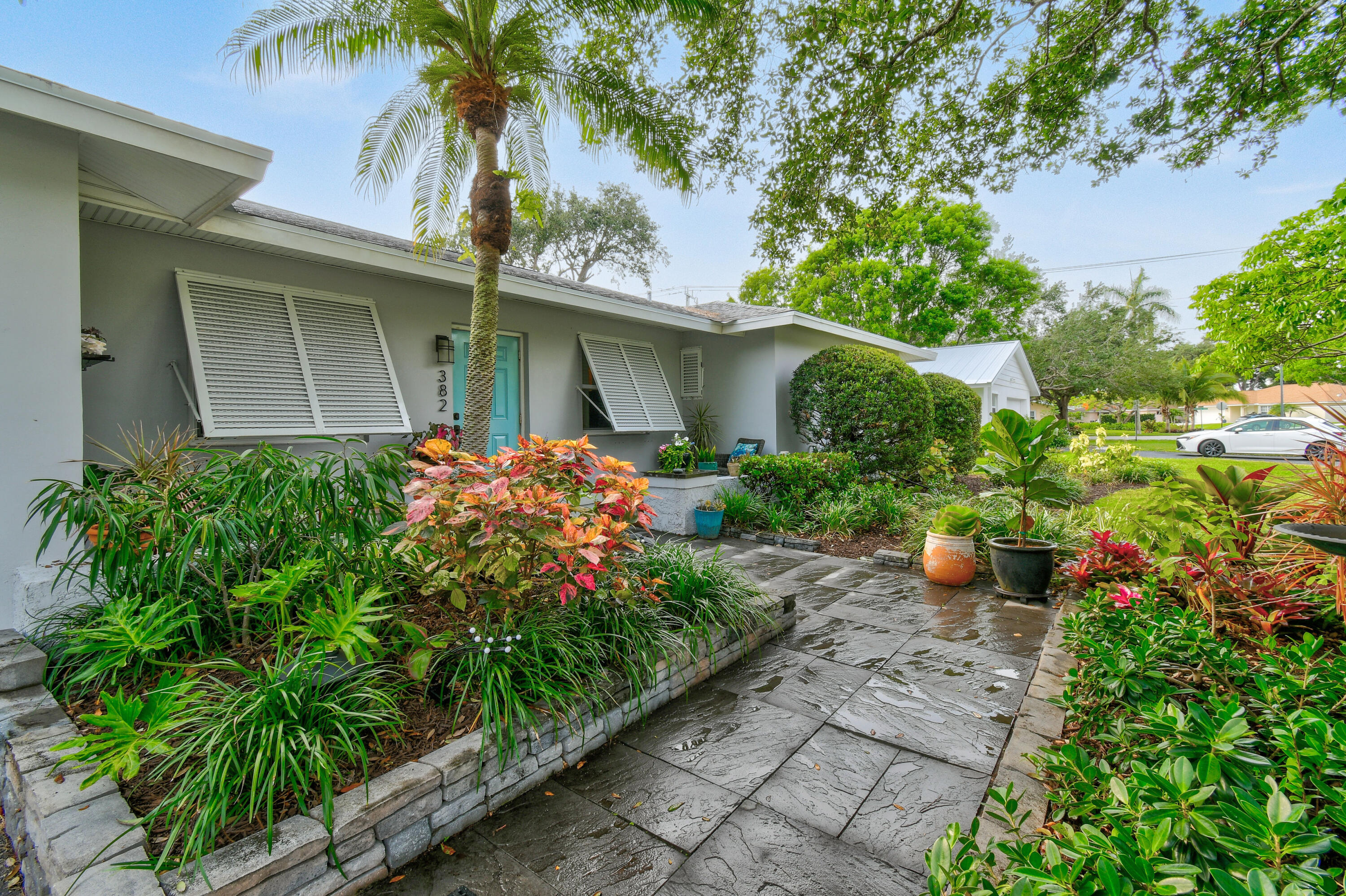 a front view of a house with a garden