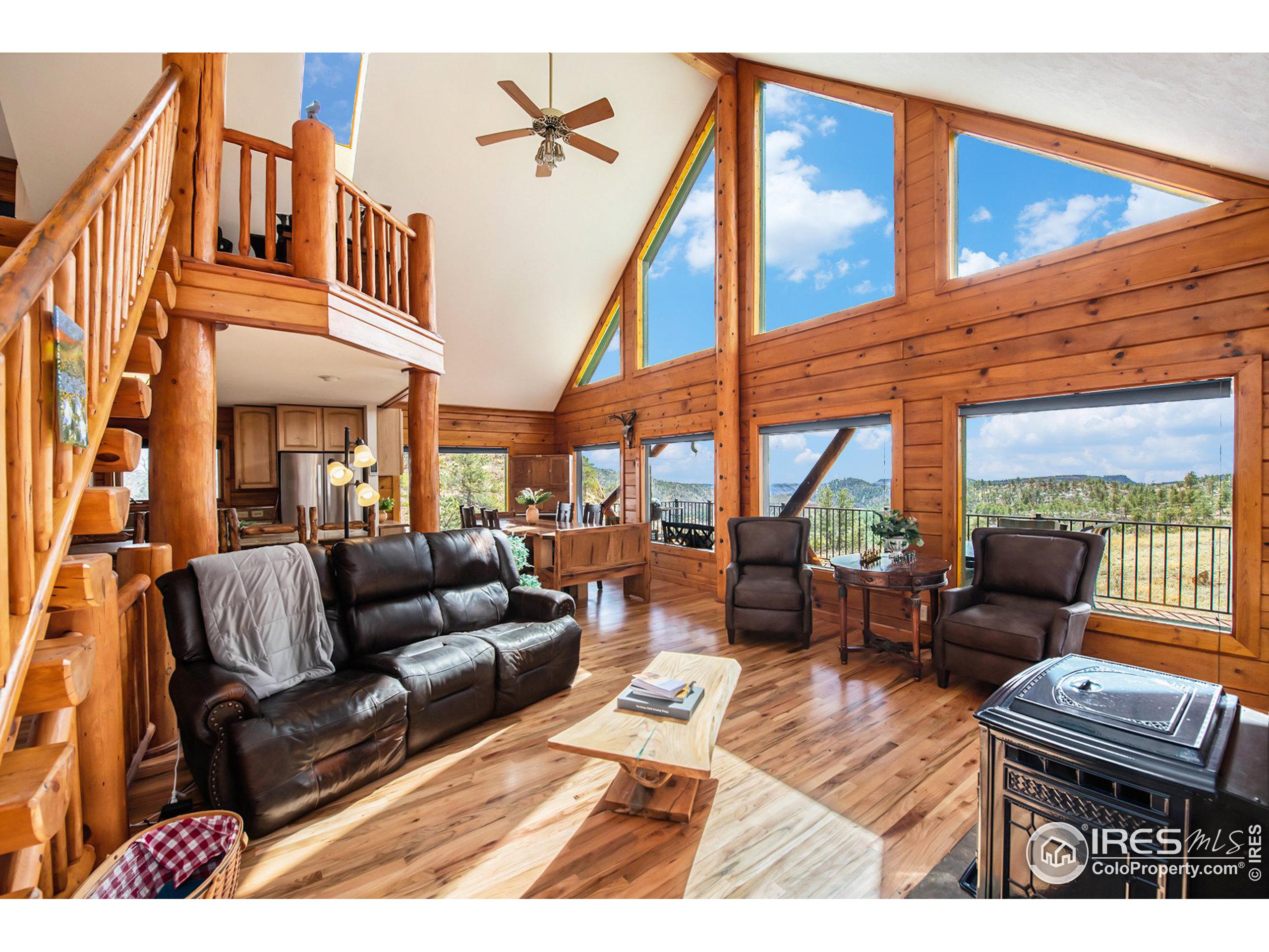 a living room with furniture a fireplace and a large window