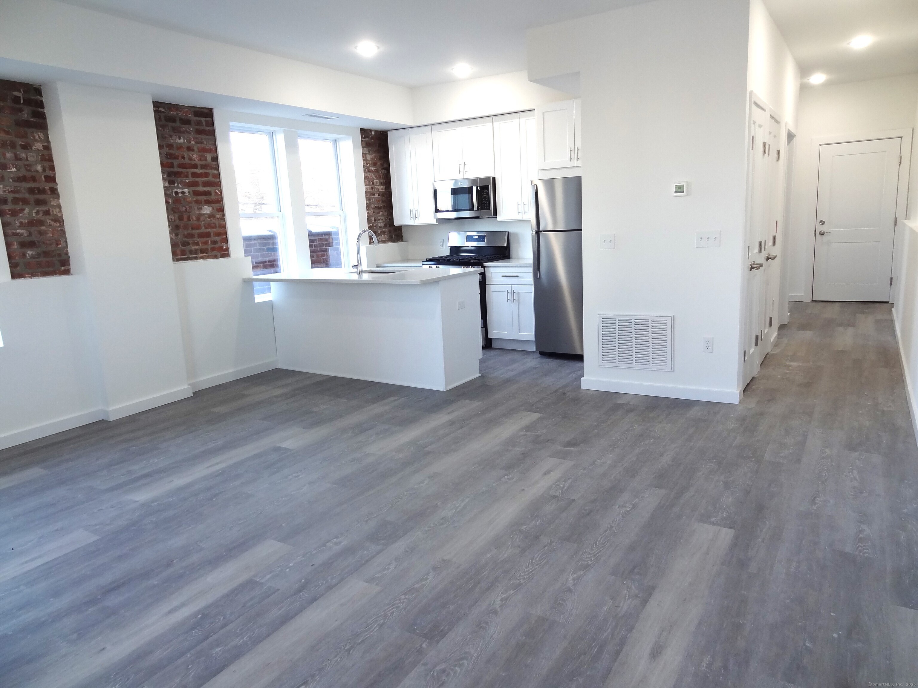 a kitchen with stainless steel appliances a refrigerator sink and cabinets