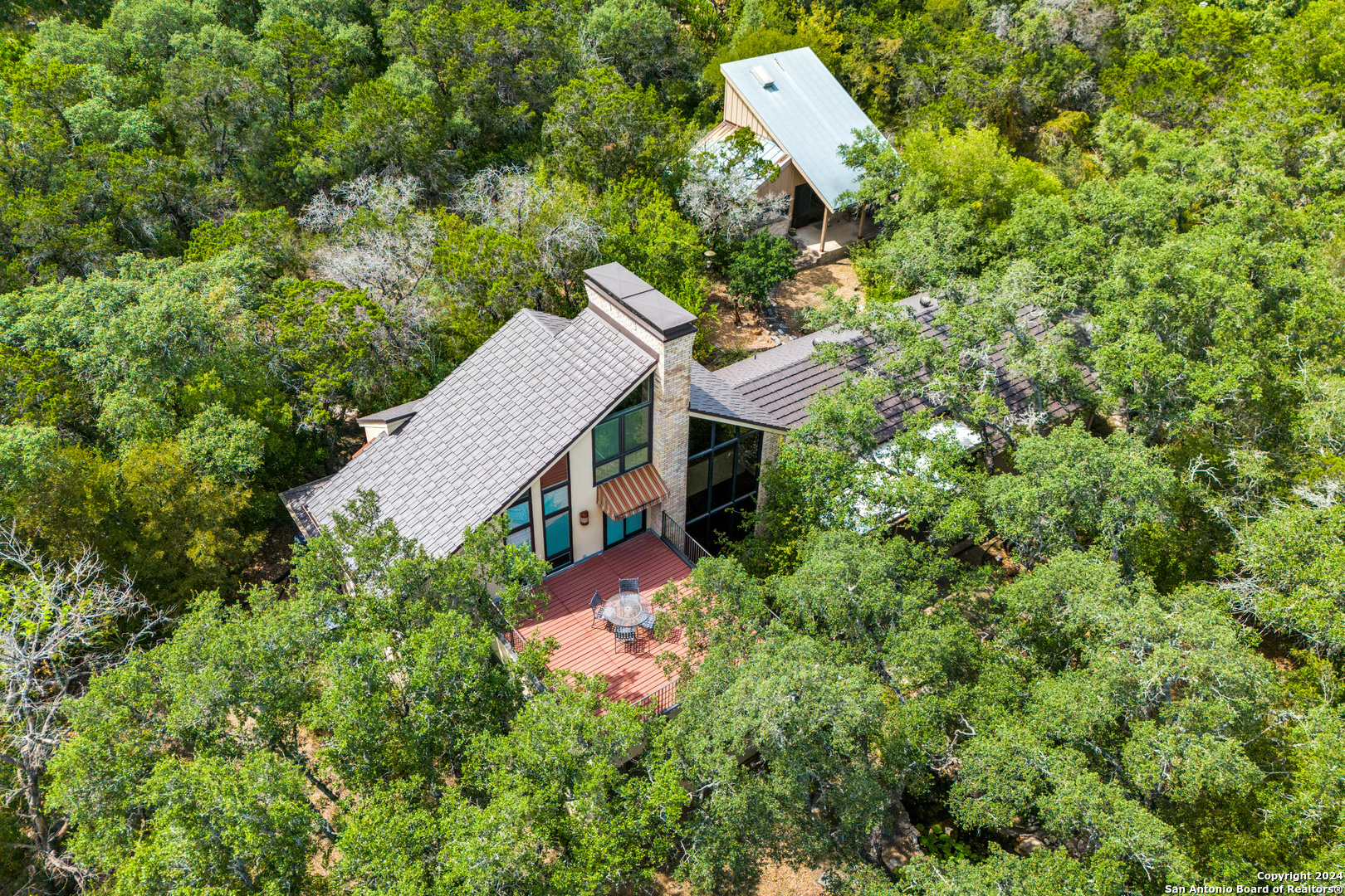 an aerial view of a house with a yard