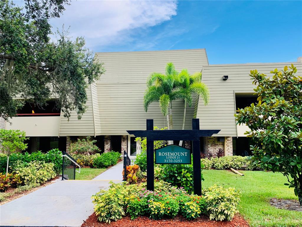 a front view of a house with garden and plants