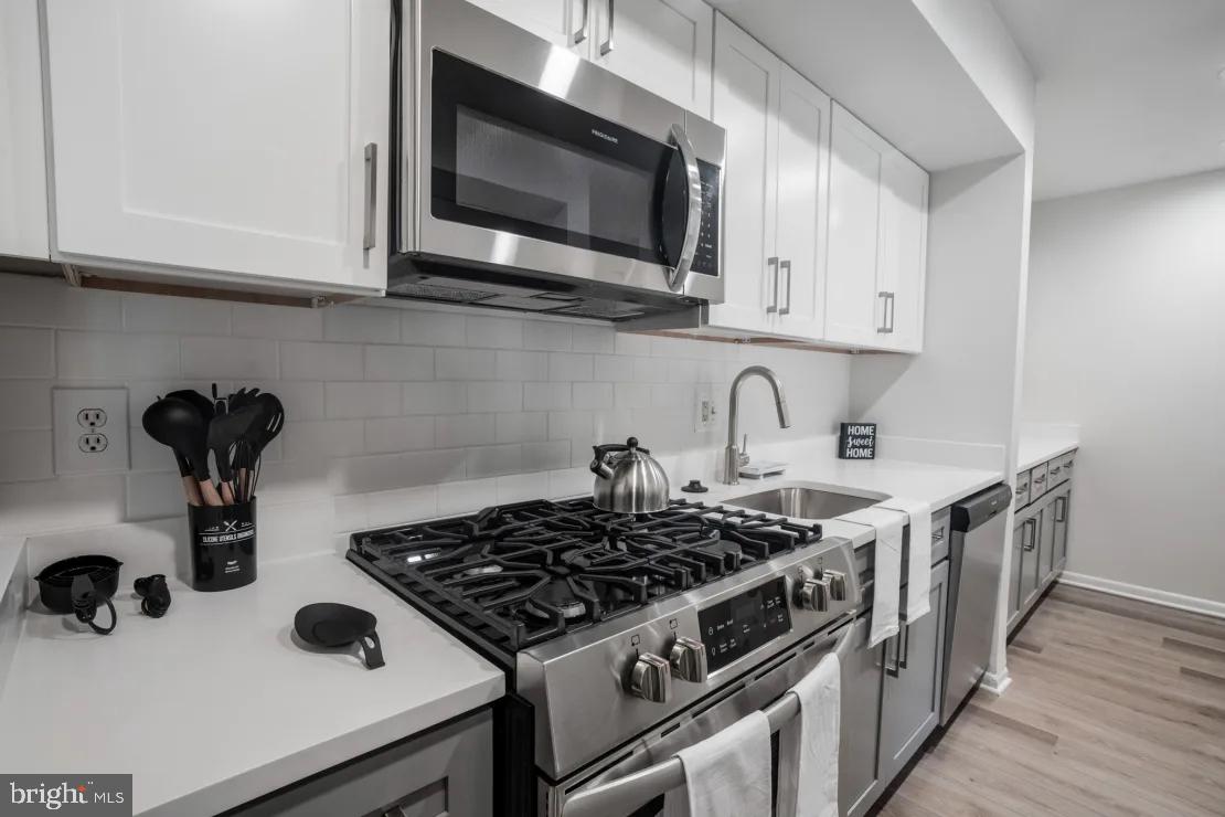 a kitchen with a stove and a microwave