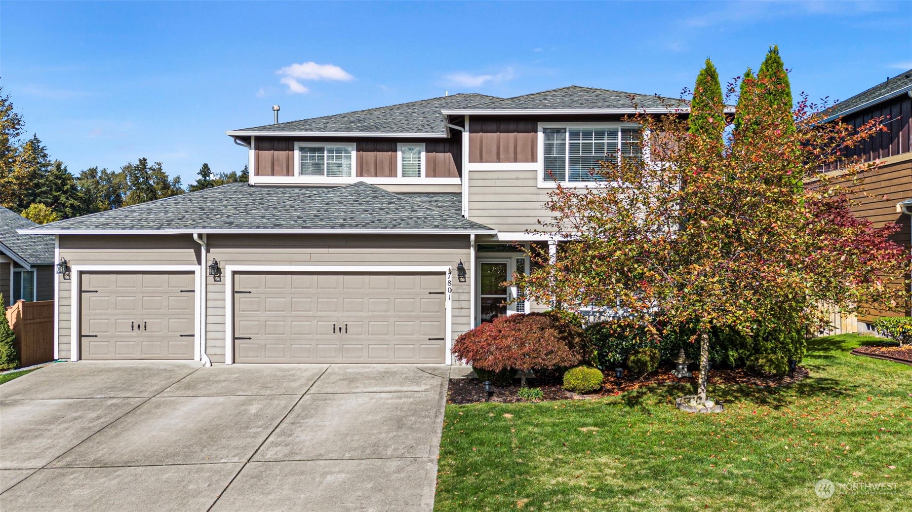 a front view of a house with a yard and garage