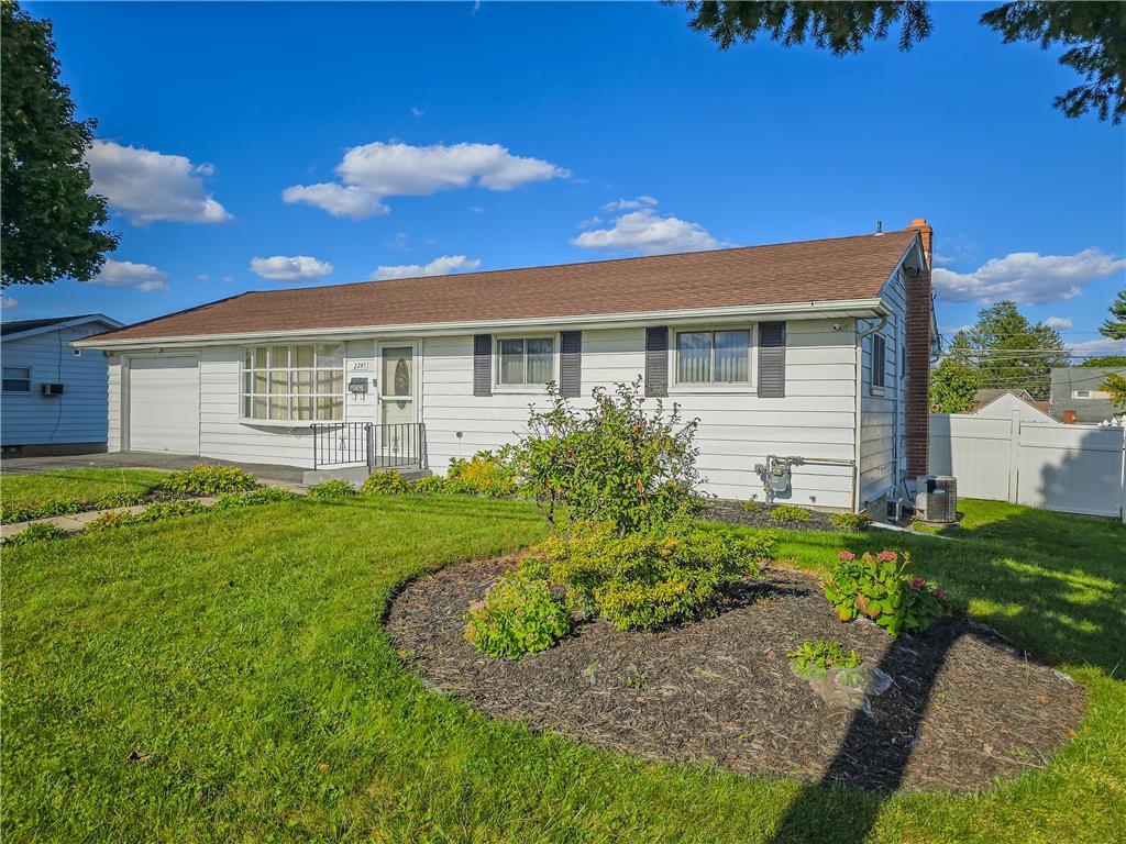 a front view of a house with a garden and yard