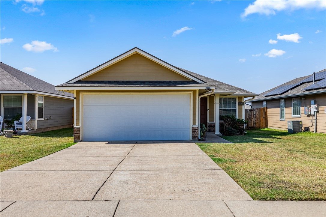 Ranch-style house with a front lawn, central air c