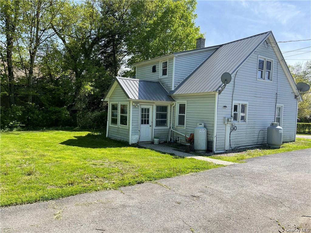 Back of house featuring a yard