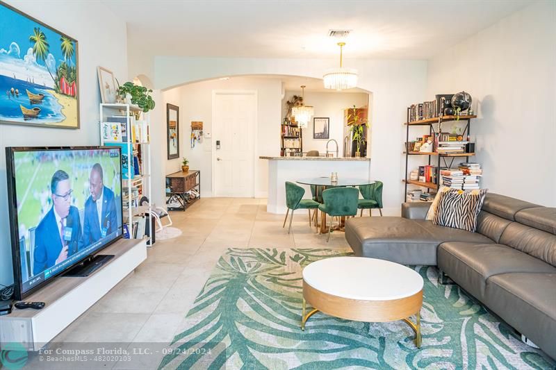 a living room with furniture a rug and a chandelier