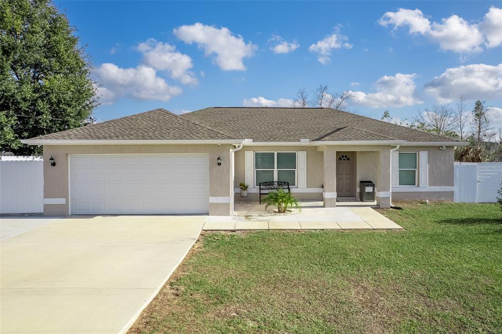 a front view of house with yard and seating space