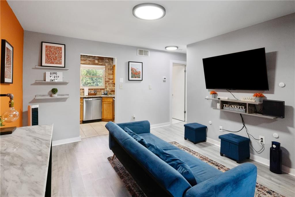 a living room with furniture and a flat screen tv