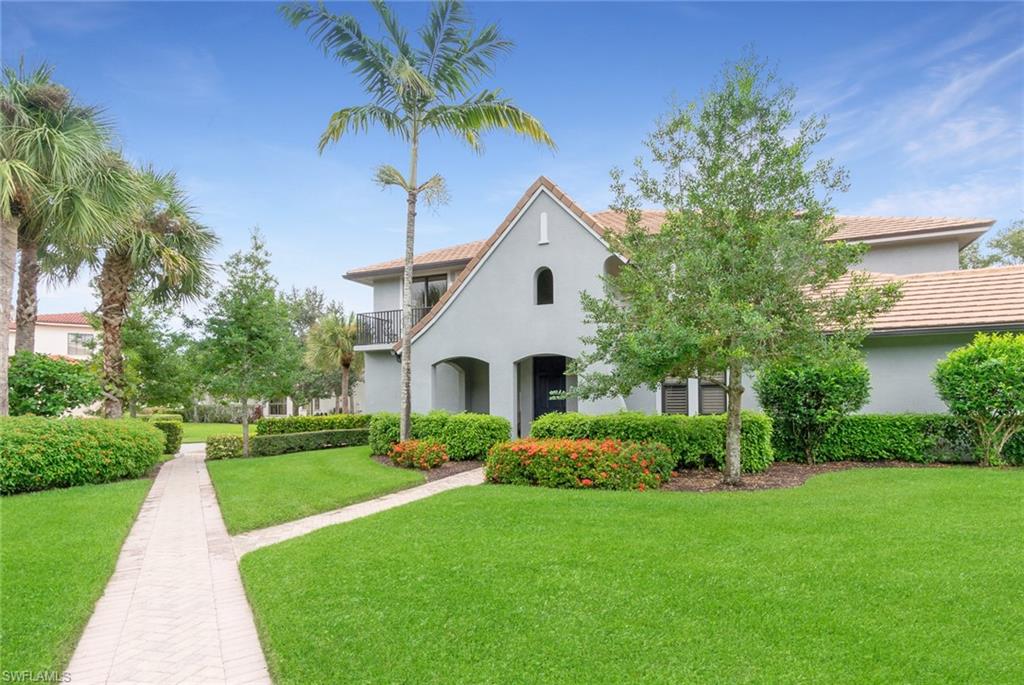 Mediterranean / spanish home featuring a balcony and a front lawn