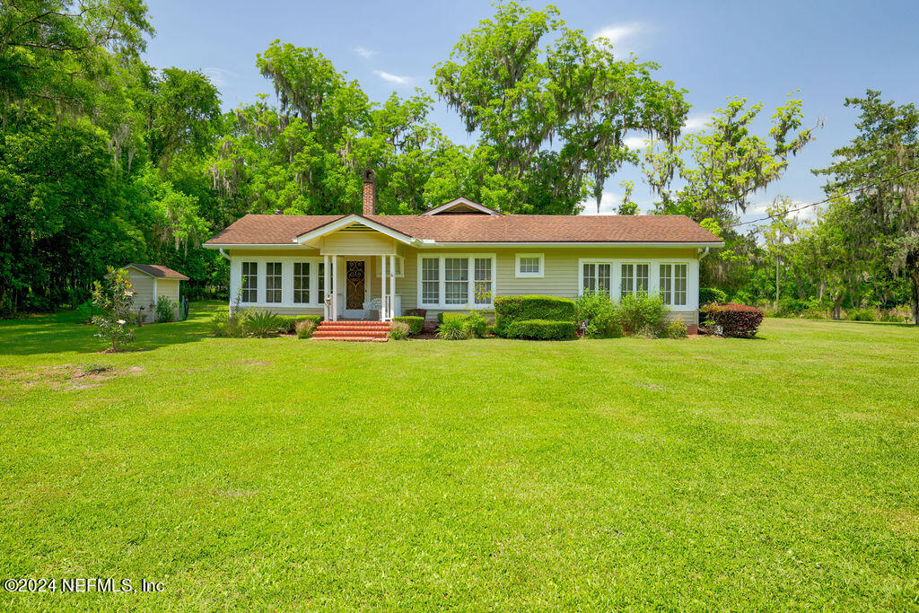 a front view of a house with a yard table and chairs