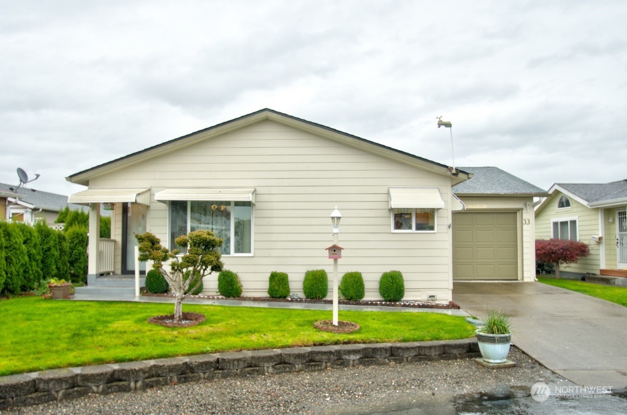 a front view of house with yard and green space