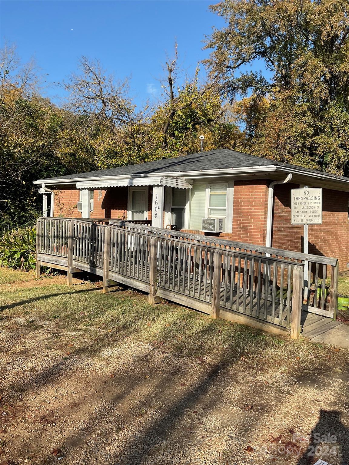 a view of a house with a yard and wooden fence