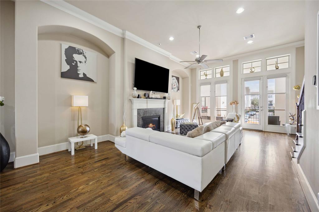 a living room with furniture a flat screen tv and a fireplace