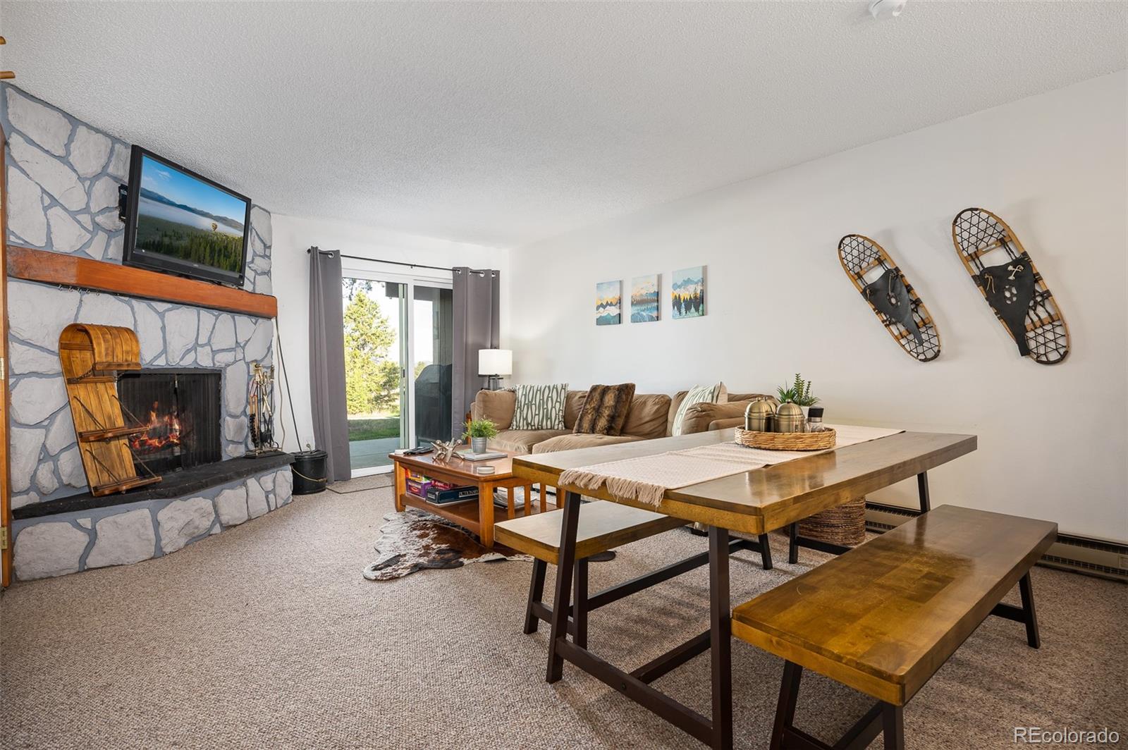 a living room with furniture a flat screen tv and a fireplace