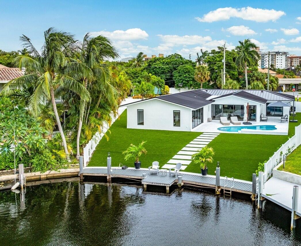 a view of house with swimming pool outdoor seating