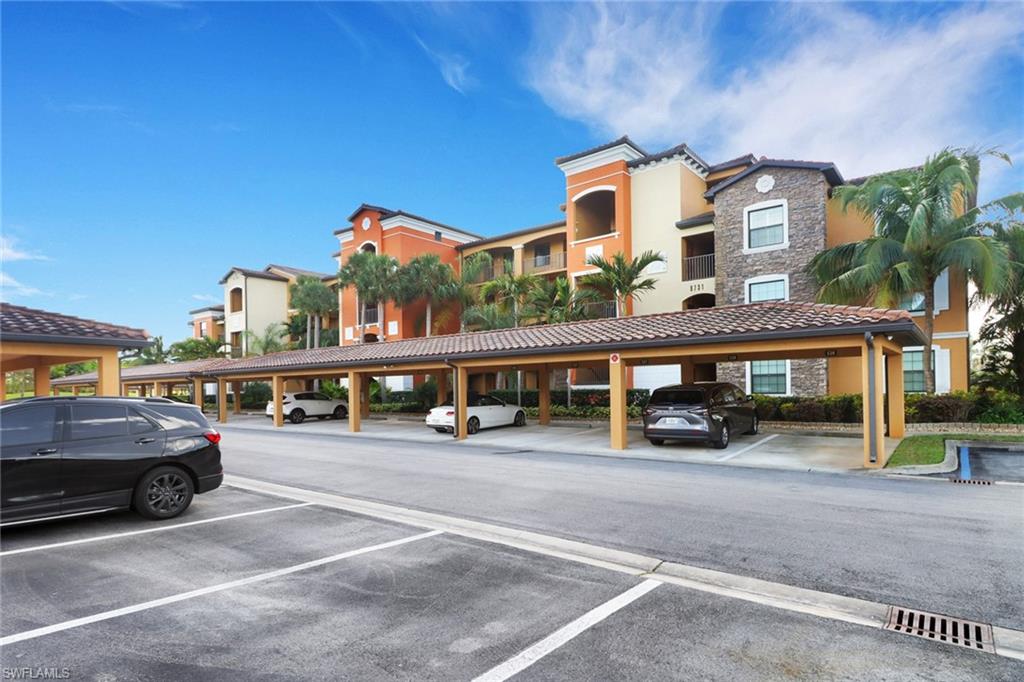 a front view of building with cars parked