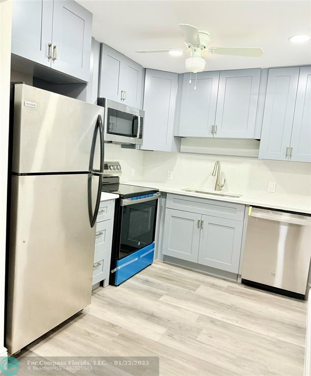 a white refrigerator freezer sitting in a kitchen