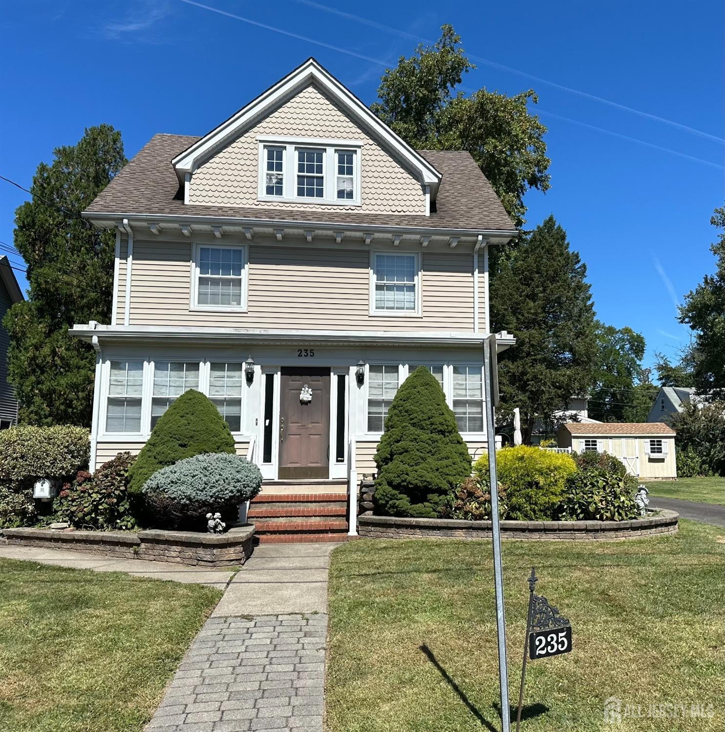 a front view of a house with garden