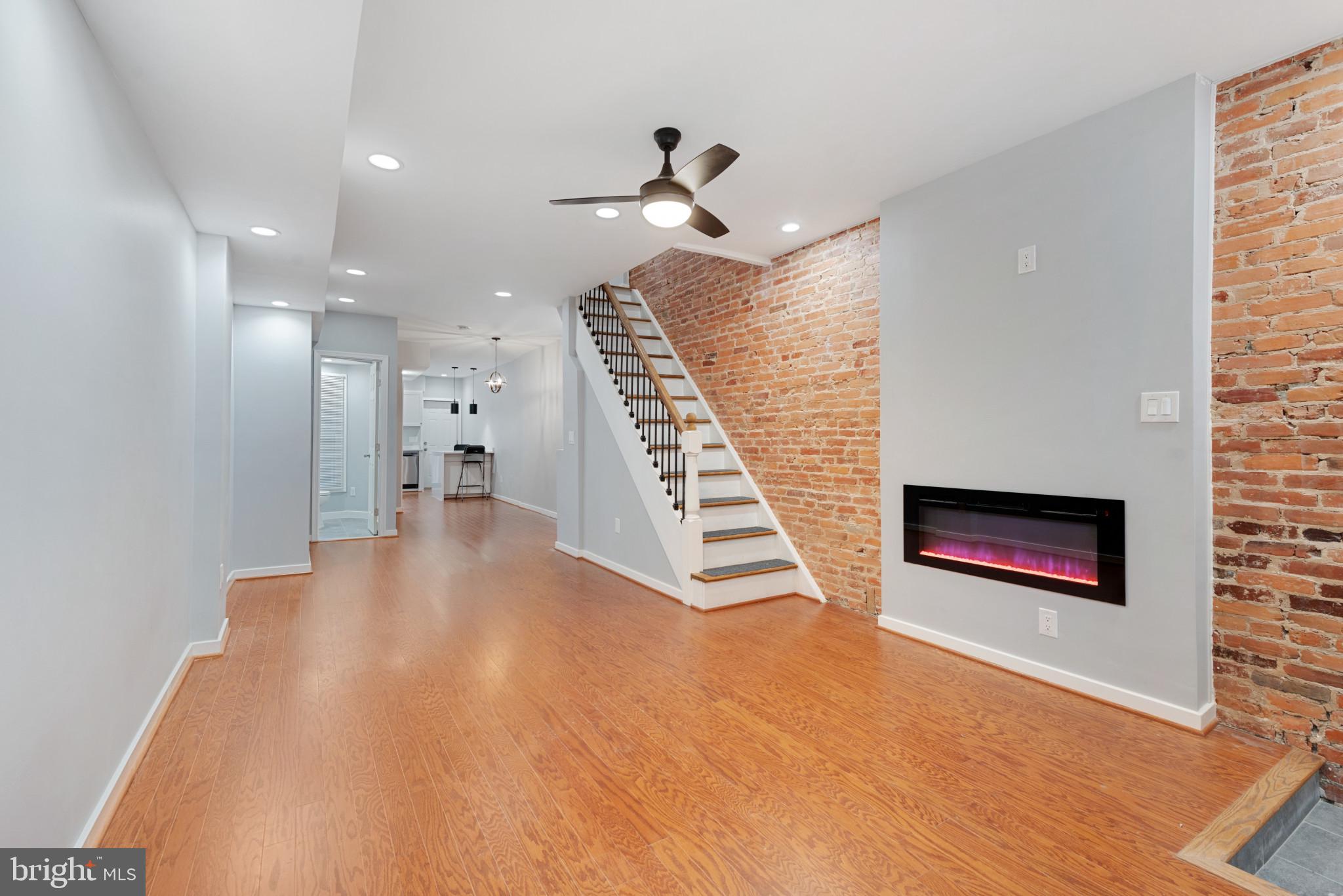 wooden floor in an empty room with a fireplace