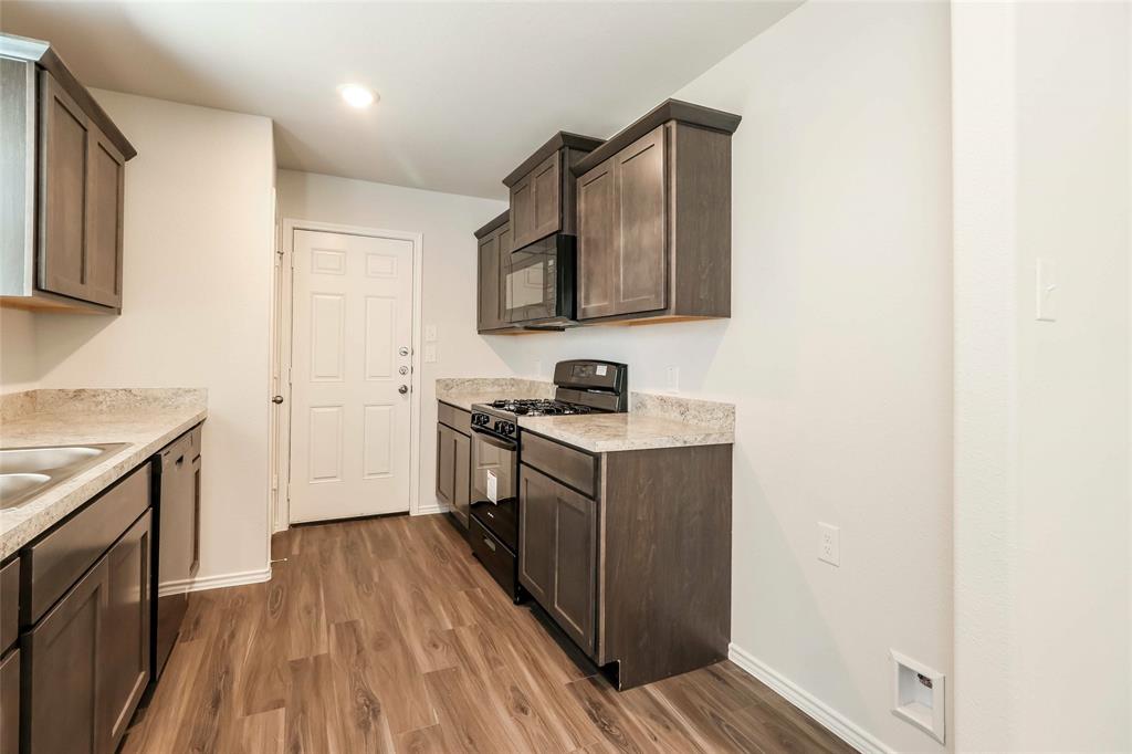 a kitchen with a sink and a stove top oven