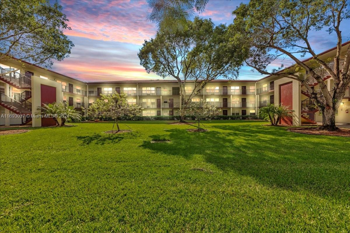 a view of a building with a yard