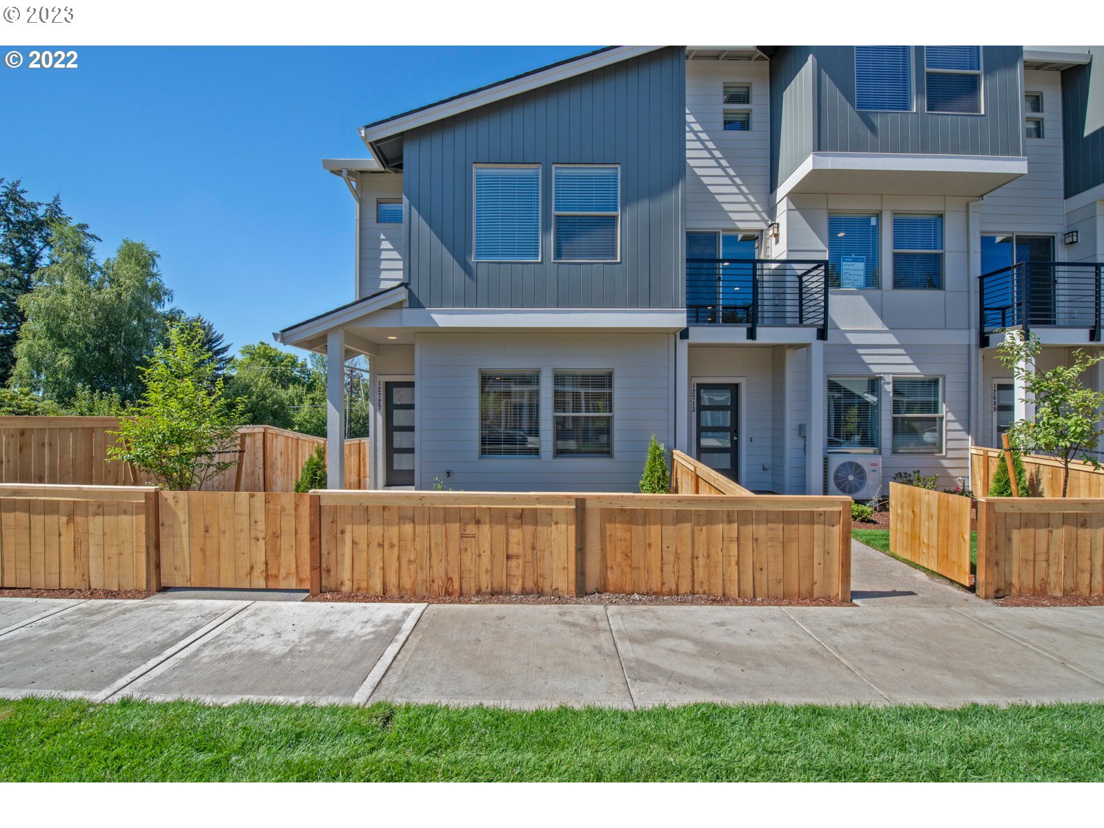 a view of a house with a yard and sitting area