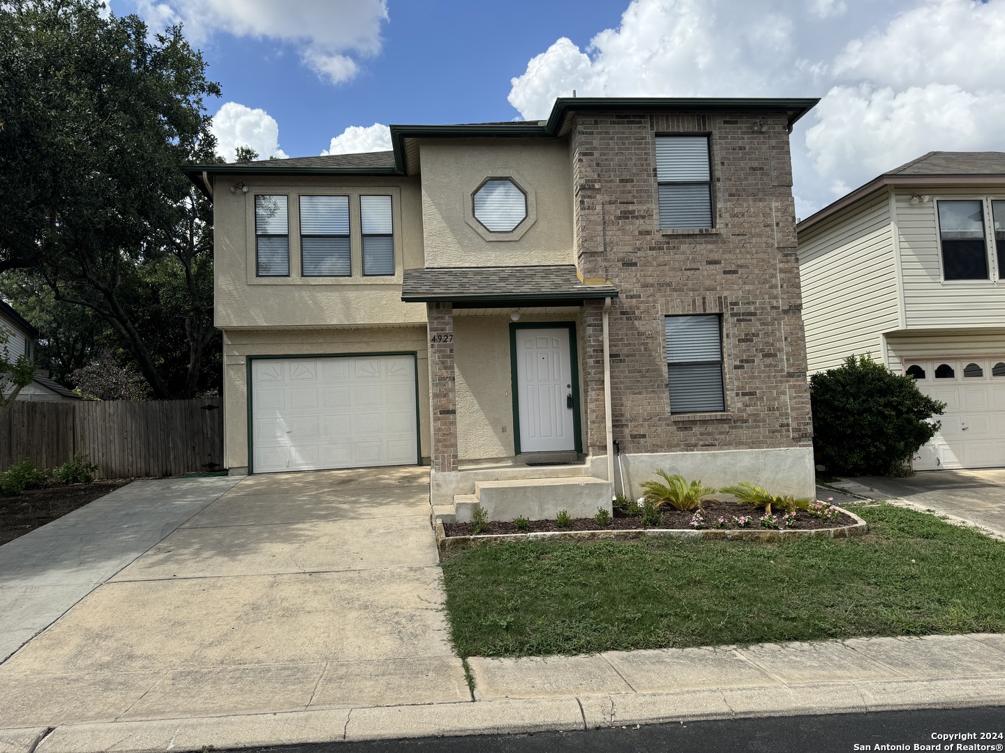 a front view of a house with garden