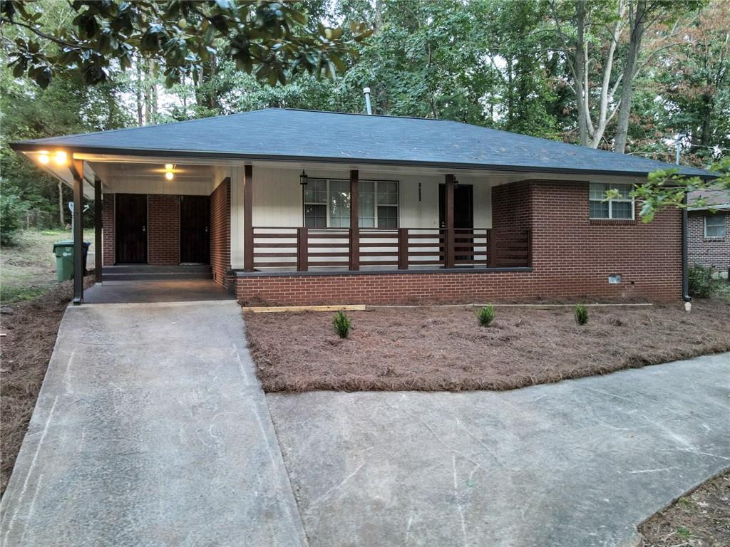 a front view of a house with a yard and porch