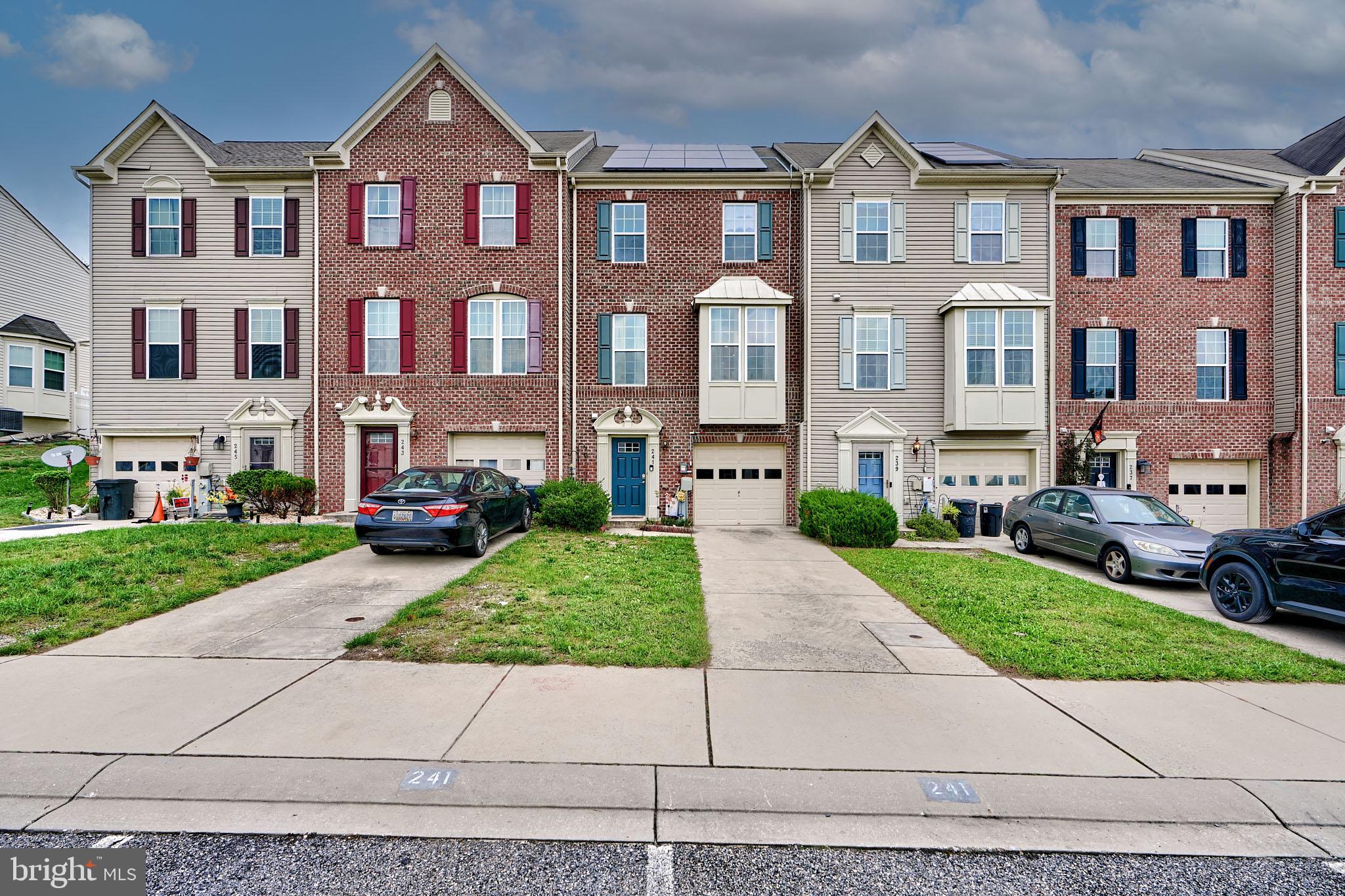 a front view of residential houses with yard