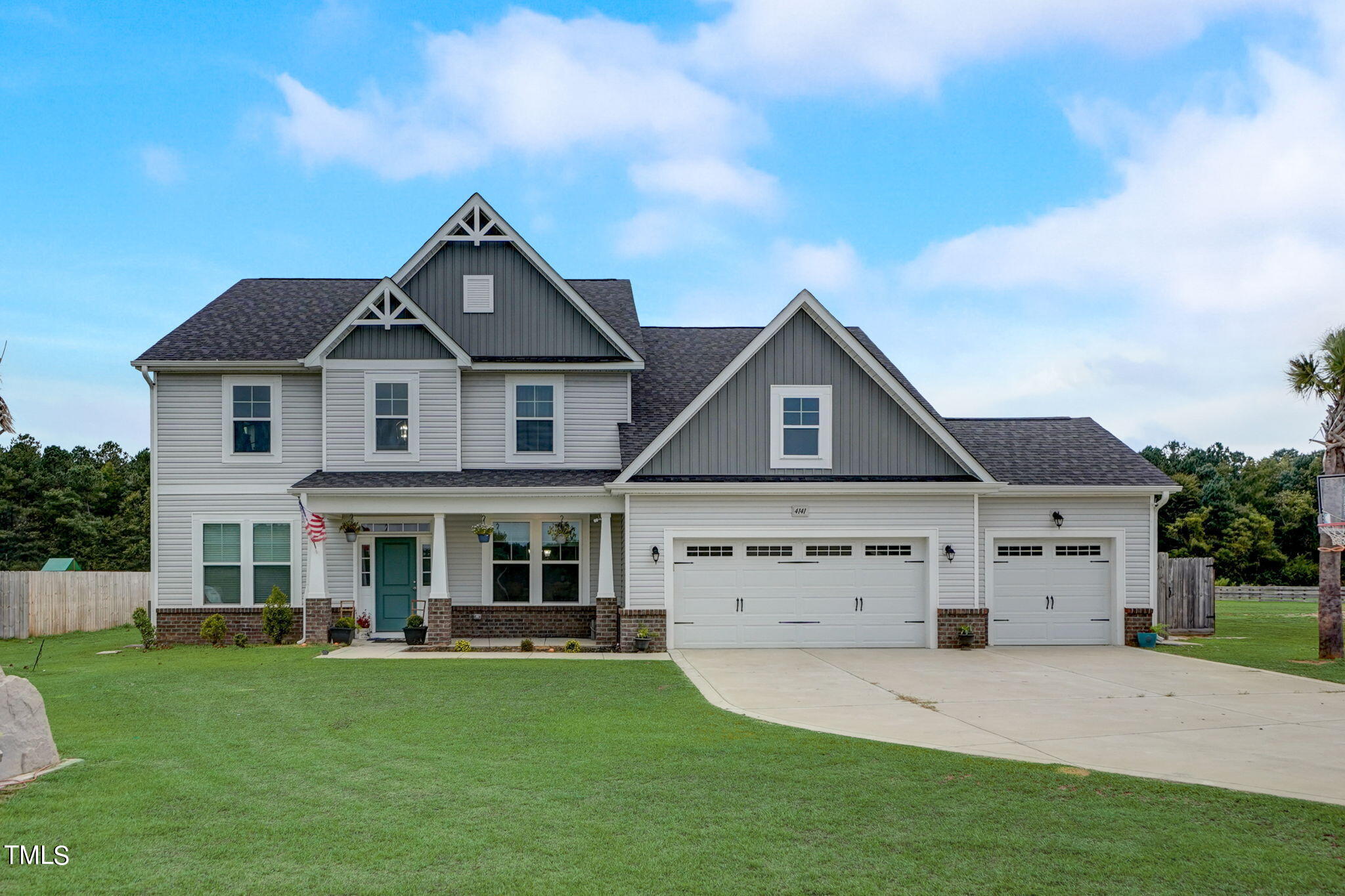 a front view of a house with a garden and yard