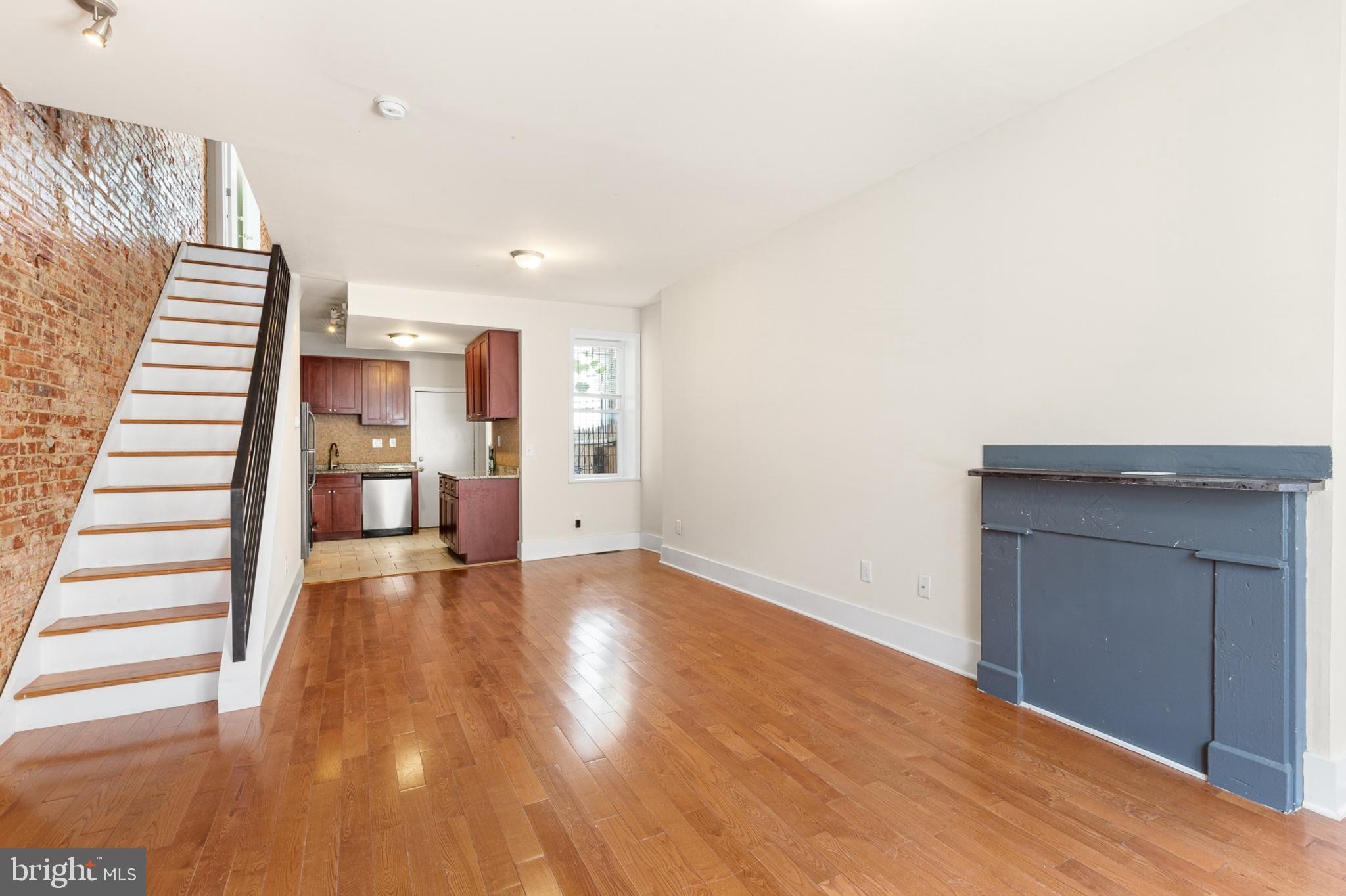 a view of a room with wooden floor and stairs