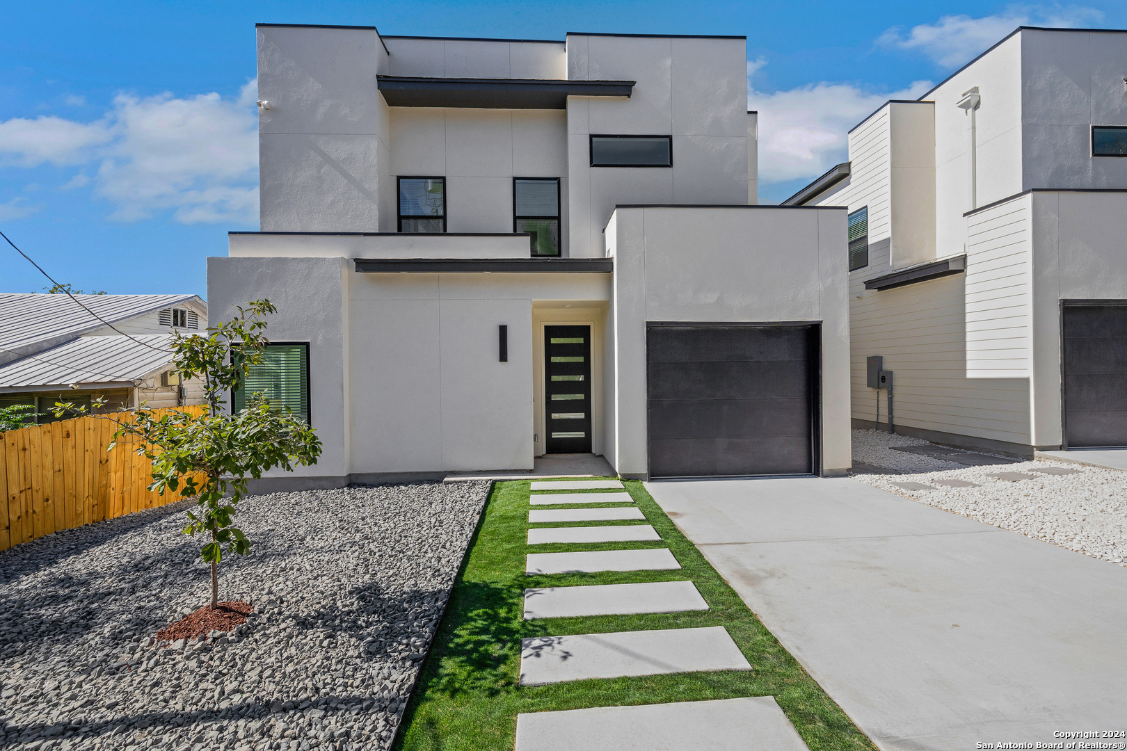 a front view of a house with a garden