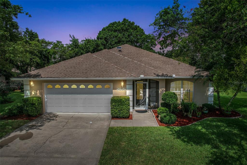 a front view of a house with a yard and garage