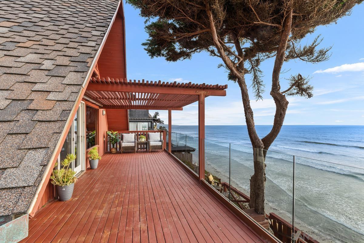 a view of a terrace with wooden floors and trees