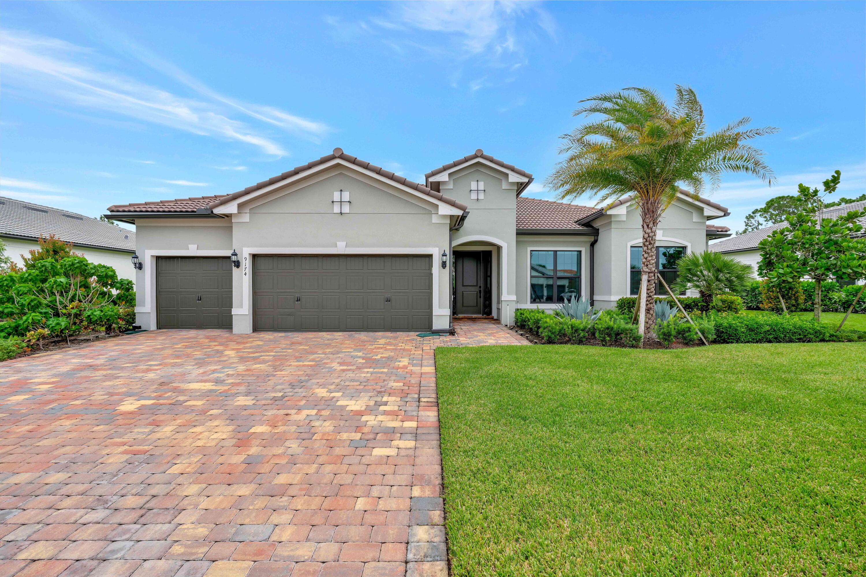 a front view of a house with a yard and garage