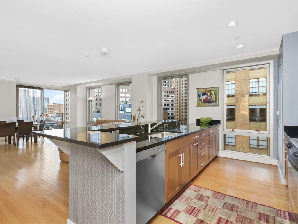 a large kitchen with granite countertop a large counter top furniture and a stove