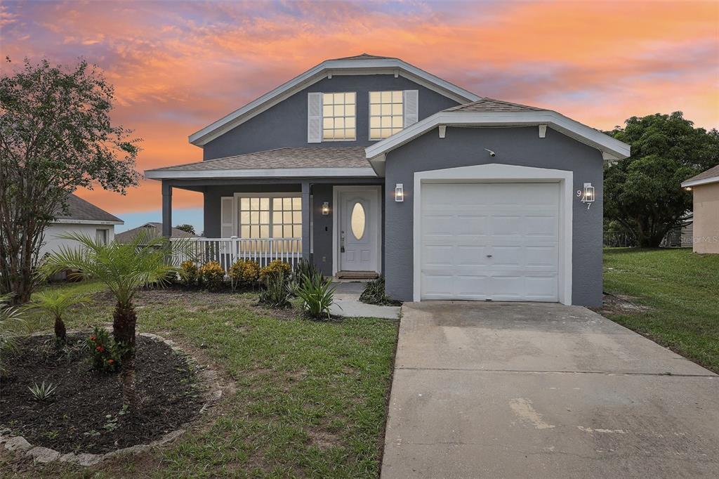 a front view of a house with a yard and garage