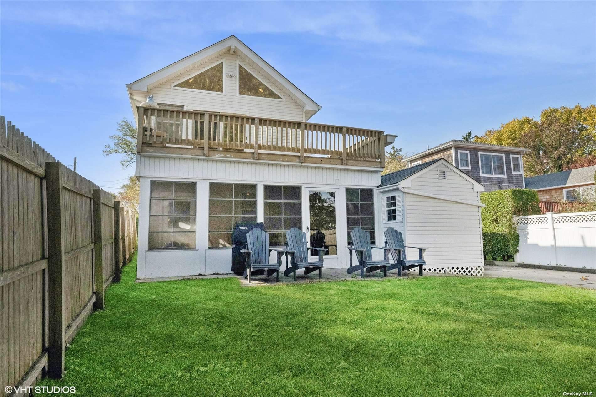 a front view of house with yard and outdoor seating