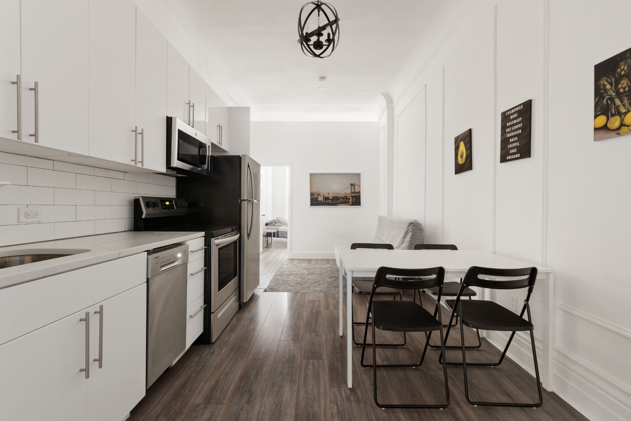 a kitchen with a sink cabinets and wooden floor